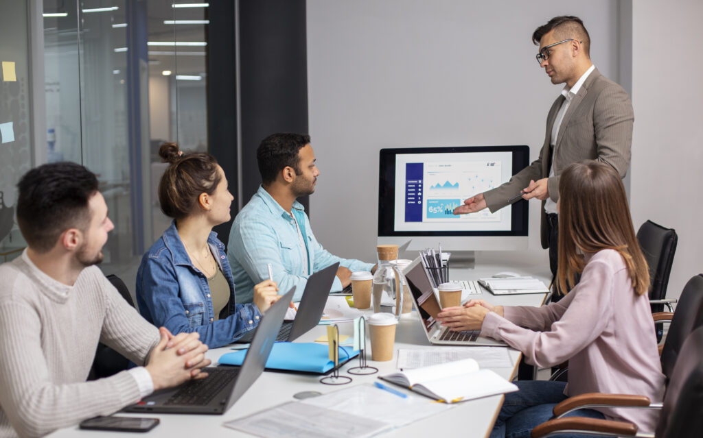 Digital strategy consultant presenting analytics to a business team