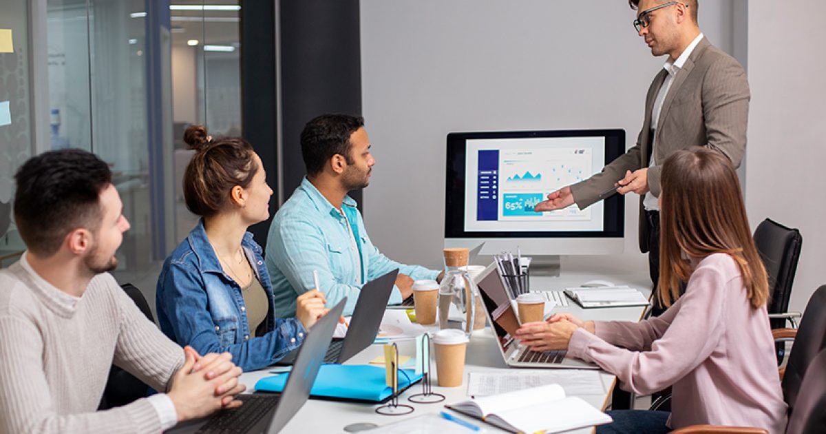 Marketing consultant presenting campaign performance data to team